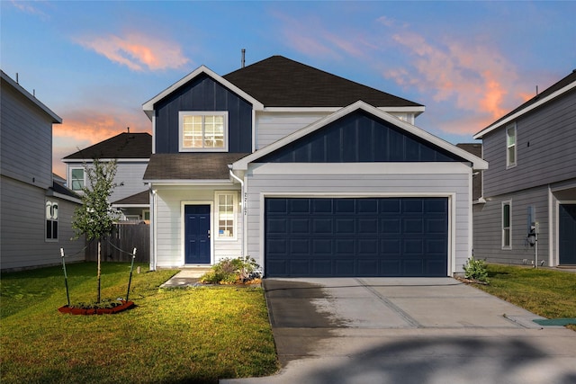 22107 King Heights Ln, Houston, TX 77073 - view of front of home with board and batten siding, driveway, an attached garage, and a front lawn