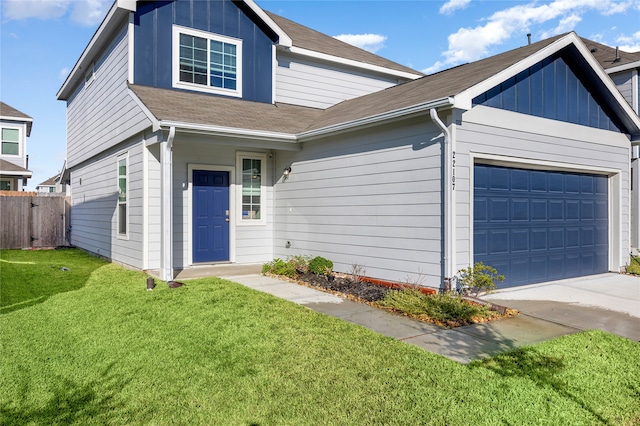 view of front of property featuring a garage and a front yard