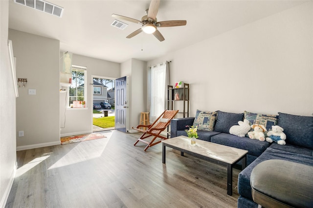 22107 King Heights Ln, Houston, TX 77073 - living area featuring wood finished floors, ceiling fan, baseboards, and visible vents