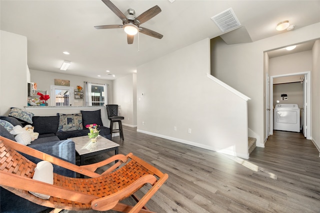 living room with washer / clothes dryer, ceiling fan, and dark hardwood / wood-style flooring