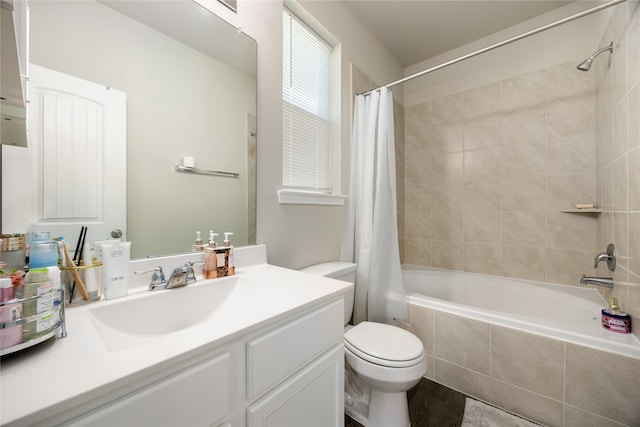 full bathroom featuring shower / bath combo, vanity, and toilet