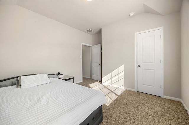 bedroom with light carpet and lofted ceiling