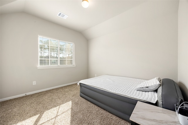 carpeted bedroom with vaulted ceiling