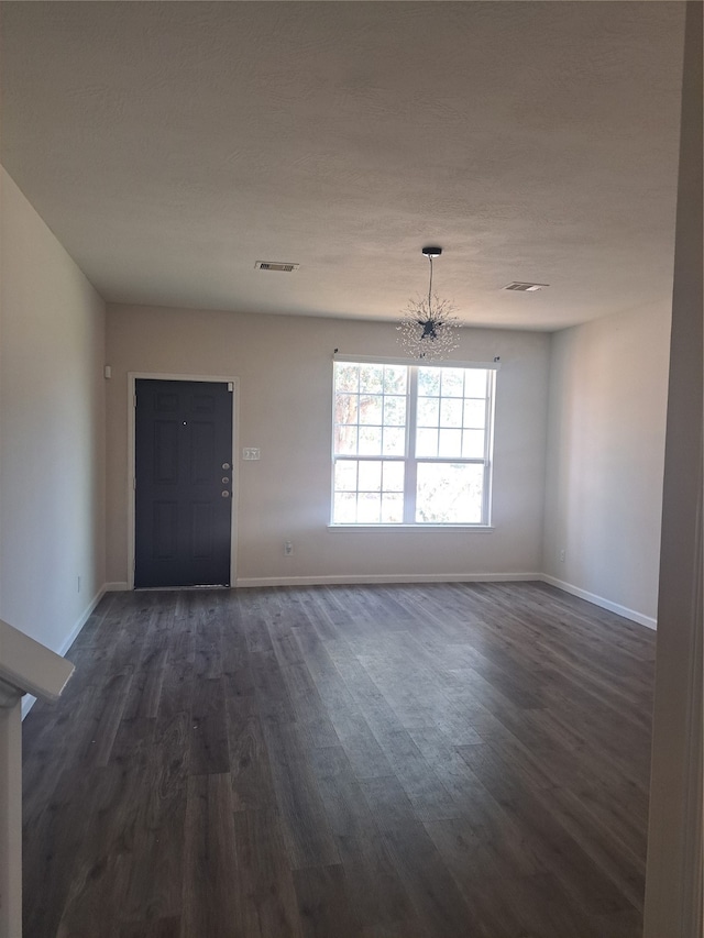 interior space featuring dark hardwood / wood-style floors and a chandelier