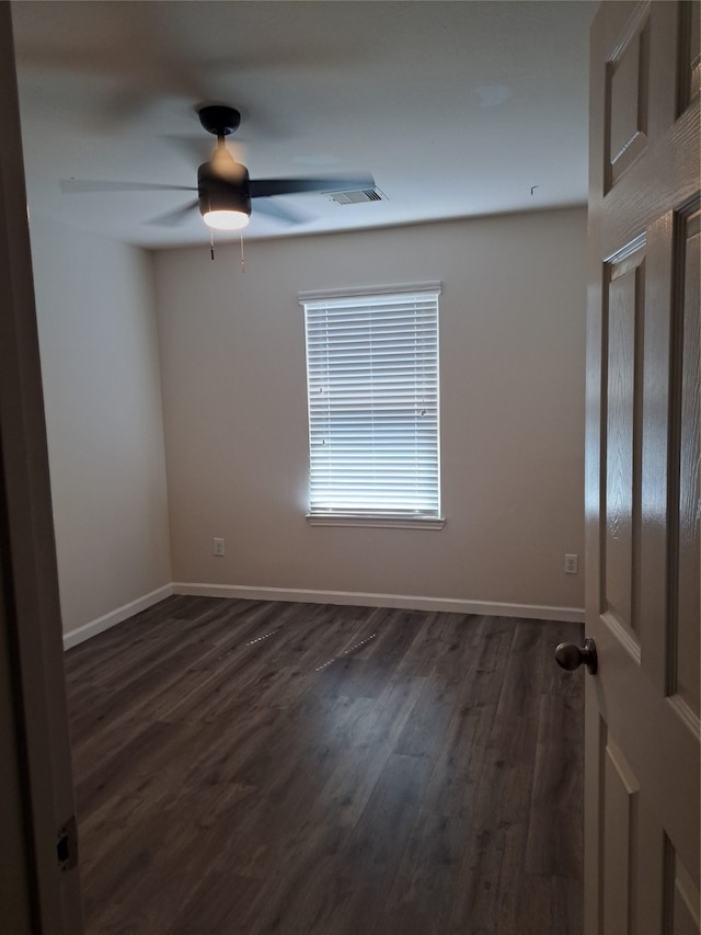 spare room with ceiling fan and dark hardwood / wood-style flooring