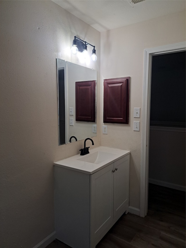 bathroom with vanity and hardwood / wood-style flooring