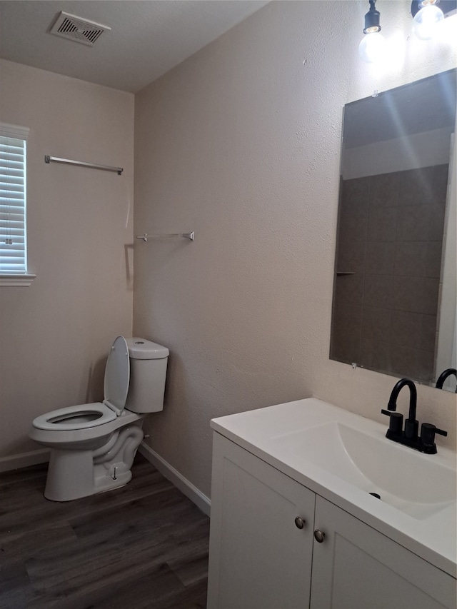 bathroom with vanity, hardwood / wood-style floors, and toilet