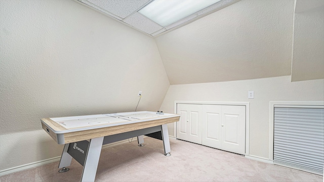 office with light carpet and vaulted ceiling