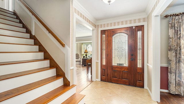 entrance foyer featuring light hardwood / wood-style flooring and ornamental molding