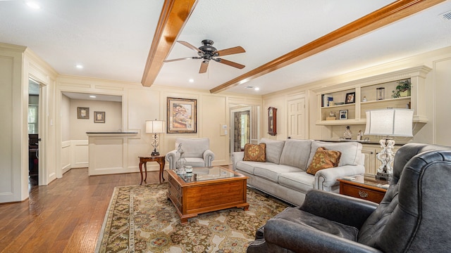 living room with ceiling fan, dark hardwood / wood-style floors, beamed ceiling, and a wealth of natural light