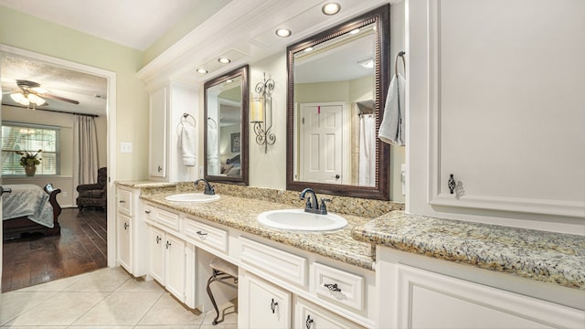 bathroom with wood-type flooring, ceiling fan, and vanity