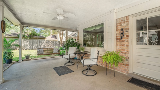 sunroom / solarium featuring ceiling fan