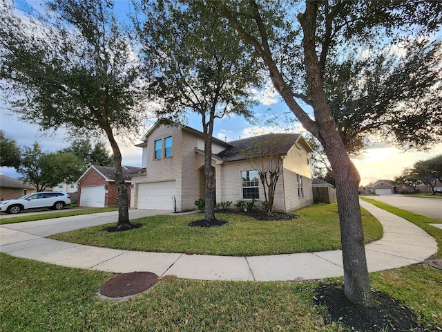 view of front of property featuring a yard and a garage