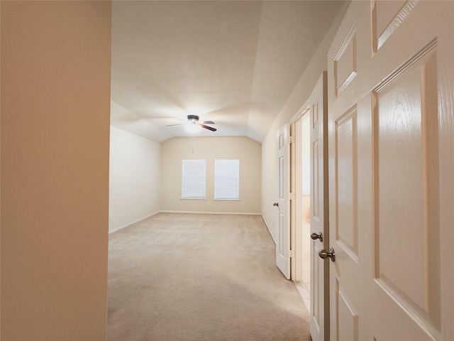 carpeted empty room with ceiling fan and lofted ceiling