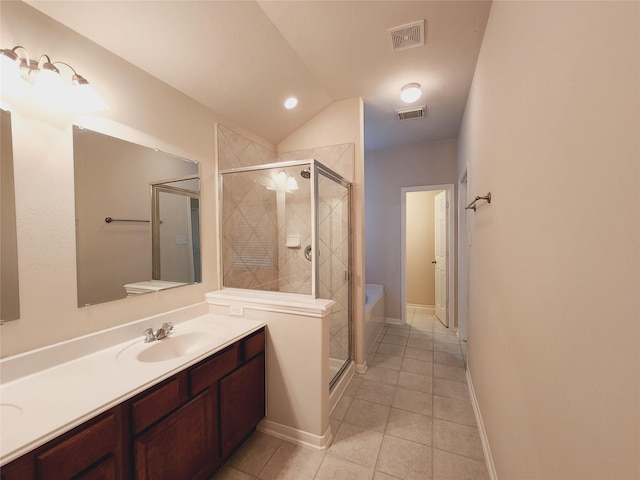 bathroom with tile patterned flooring, lofted ceiling, vanity, and independent shower and bath