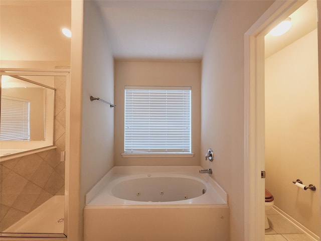 bathroom with tile patterned flooring, independent shower and bath, and toilet