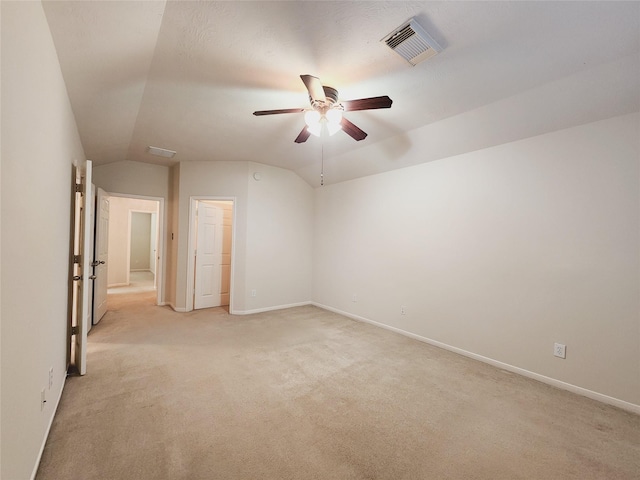 unfurnished room featuring light carpet, ceiling fan, and lofted ceiling