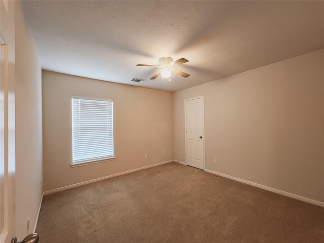 unfurnished room with carpet and ceiling fan