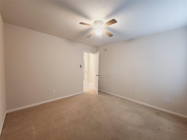 carpeted spare room with ceiling fan and a textured ceiling