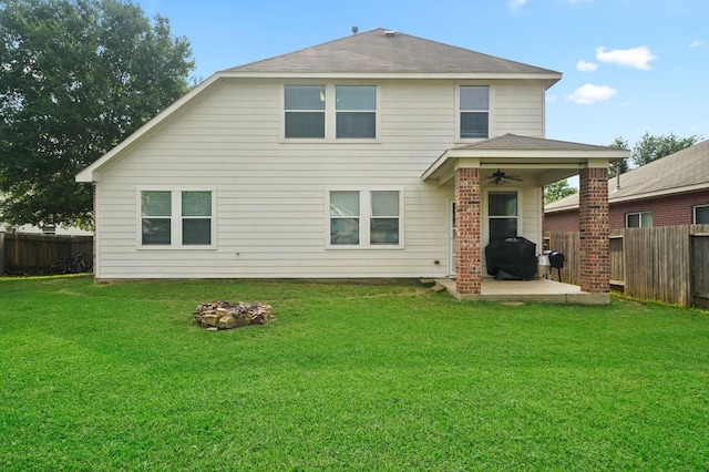 rear view of house with a lawn, ceiling fan, and a patio area