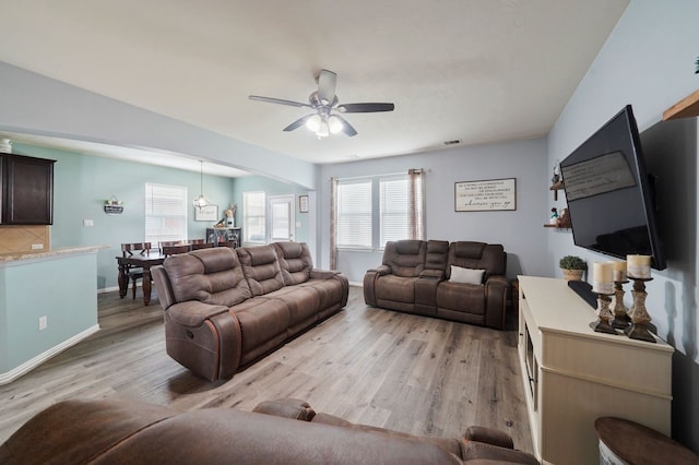 living room with ceiling fan and light hardwood / wood-style floors