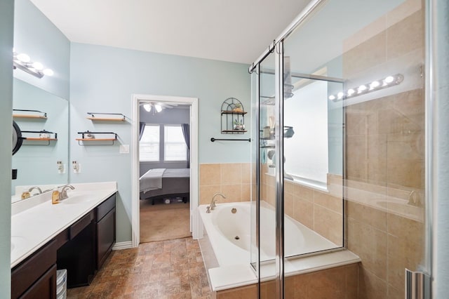 bathroom with vanity and shower with separate bathtub