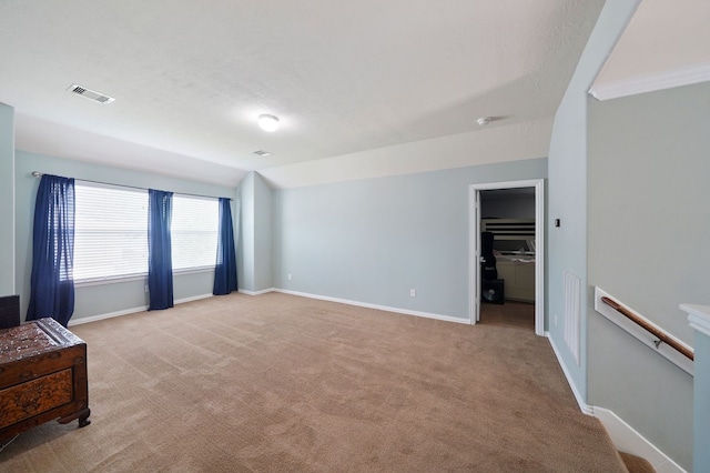 unfurnished living room featuring light colored carpet and lofted ceiling