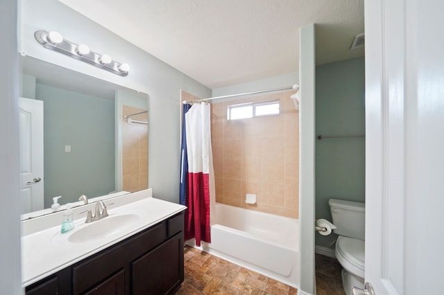 full bathroom with shower / bath combination with curtain, vanity, toilet, and a textured ceiling