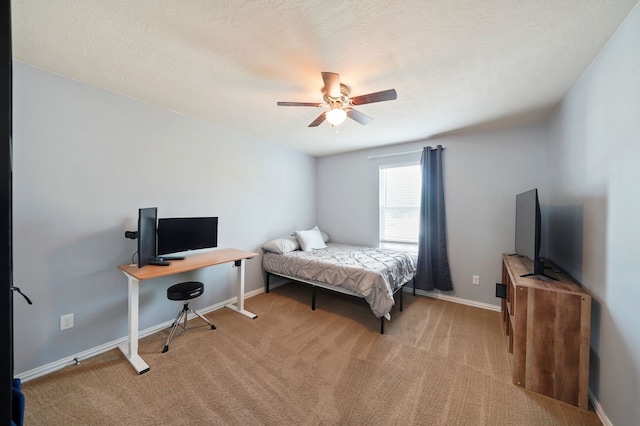 bedroom with ceiling fan, a textured ceiling, and light carpet