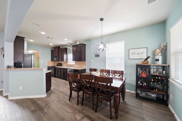 dining area with sink and hardwood / wood-style floors