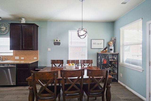 dining space with dark hardwood / wood-style flooring