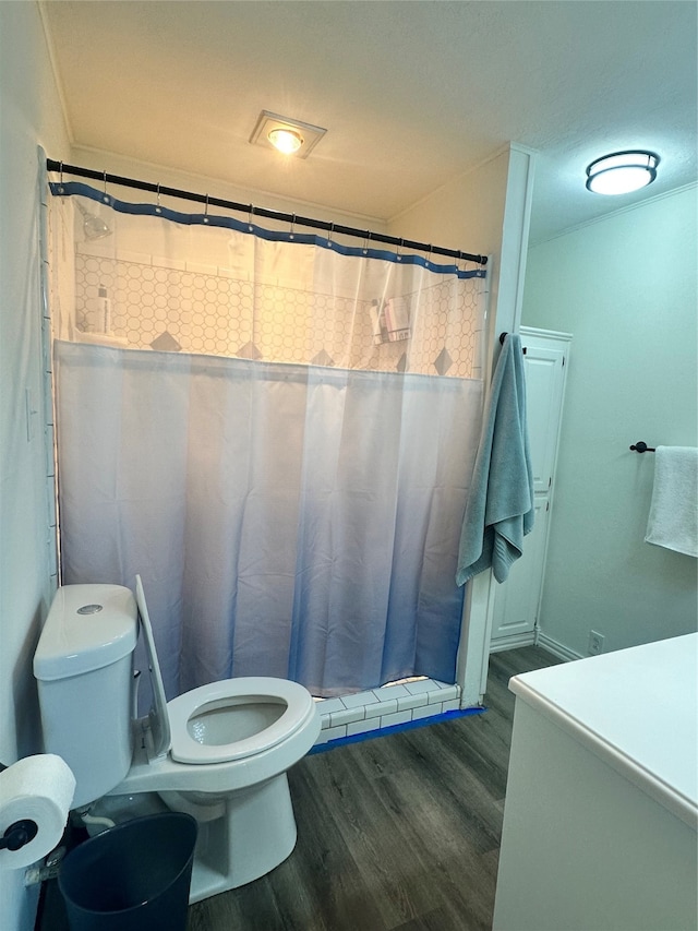 bathroom featuring vanity, a shower with shower curtain, hardwood / wood-style flooring, and toilet