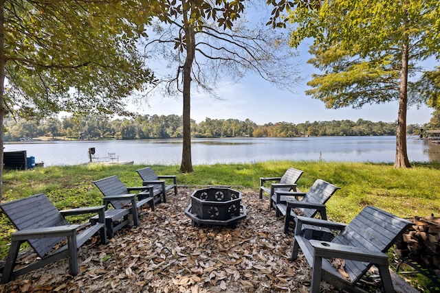 exterior space featuring a water view and an outdoor fire pit