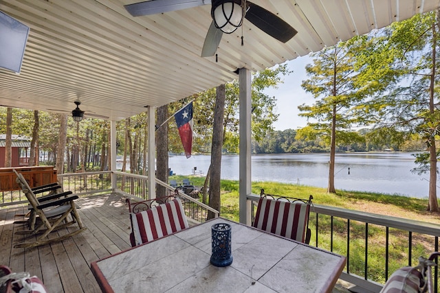 wooden deck with a water view and ceiling fan