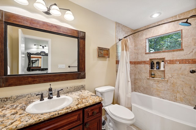 full bathroom featuring shower / tub combo with curtain, vanity, and toilet