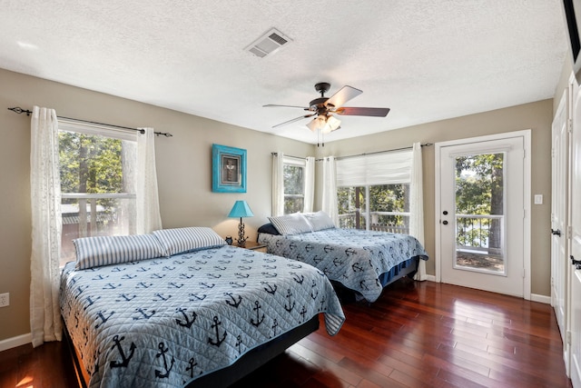 bedroom with access to outside, dark wood-type flooring, multiple windows, and ceiling fan