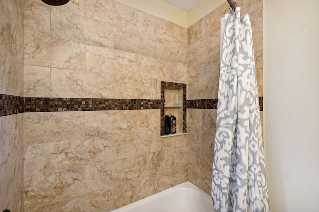 bathroom with shower / bath combination with curtain