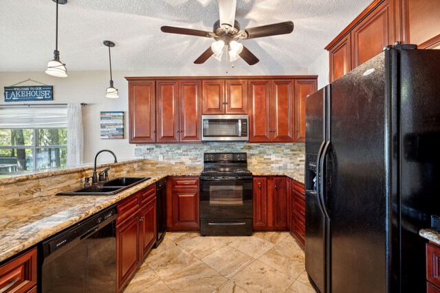 kitchen with hanging light fixtures, decorative backsplash, a textured ceiling, black appliances, and sink