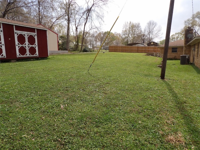 view of yard featuring a shed and central air condition unit