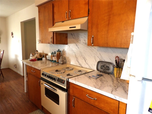 kitchen featuring dark hardwood / wood-style flooring, white appliances, and decorative backsplash