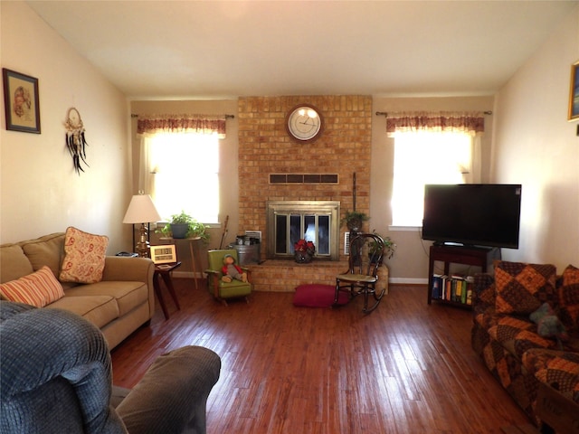 living room with wood-type flooring and a fireplace