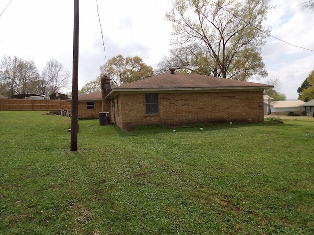 view of property exterior featuring a yard and central air condition unit