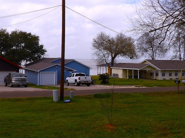 ranch-style house featuring a front yard and a garage