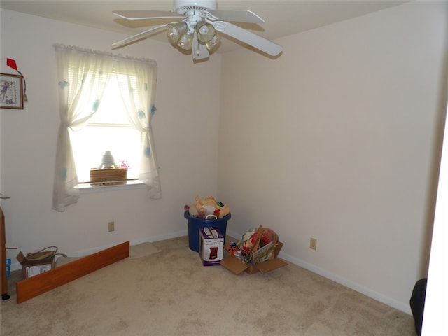 interior space featuring light carpet and ceiling fan