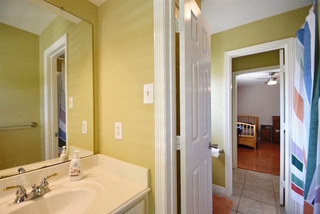 bathroom with tile patterned flooring, vanity, and ceiling fan