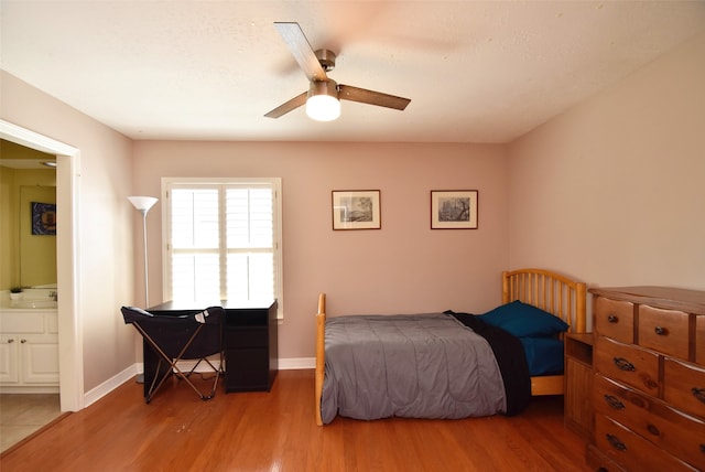 bedroom featuring wood-type flooring, connected bathroom, and ceiling fan