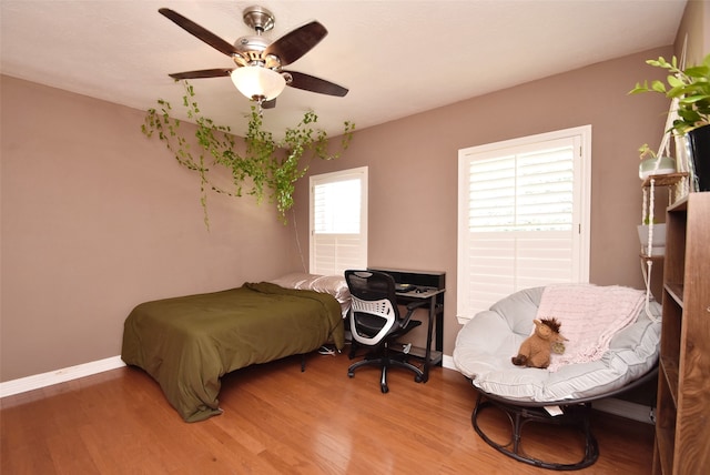 bedroom with ceiling fan and hardwood / wood-style flooring