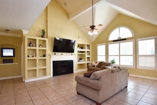 tiled living room featuring crown molding, built in shelves, ceiling fan, and high vaulted ceiling