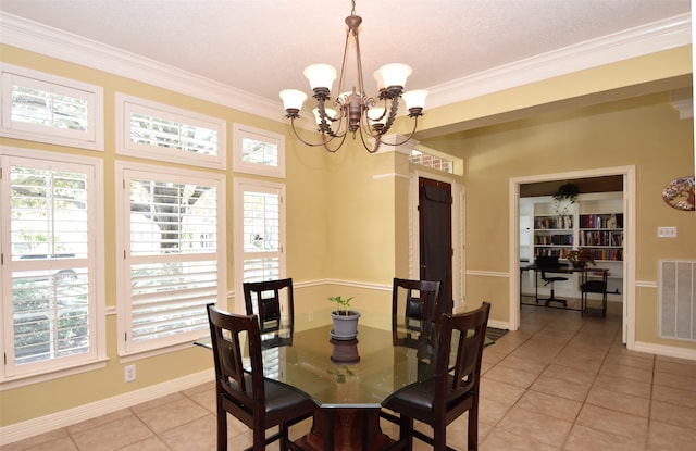 dining area with crown molding, light tile patterned floors, and a chandelier