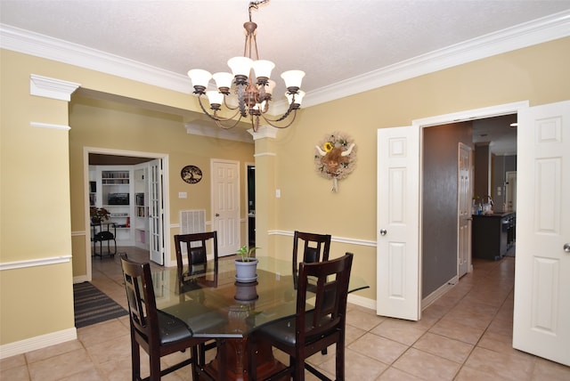 dining space featuring light tile patterned floors, a textured ceiling, crown molding, and a chandelier